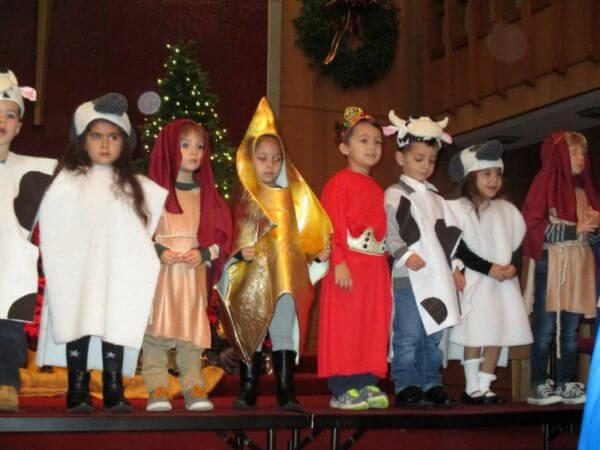 Preschoolers in various costumes at Christmas program