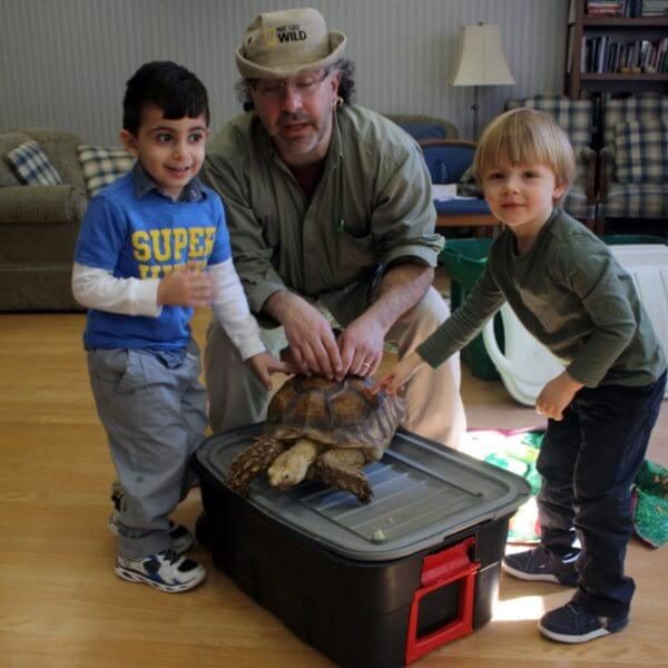 Two boys and a naturalist learn about turtles