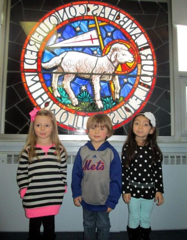 Children standing in front of Moravian Seal